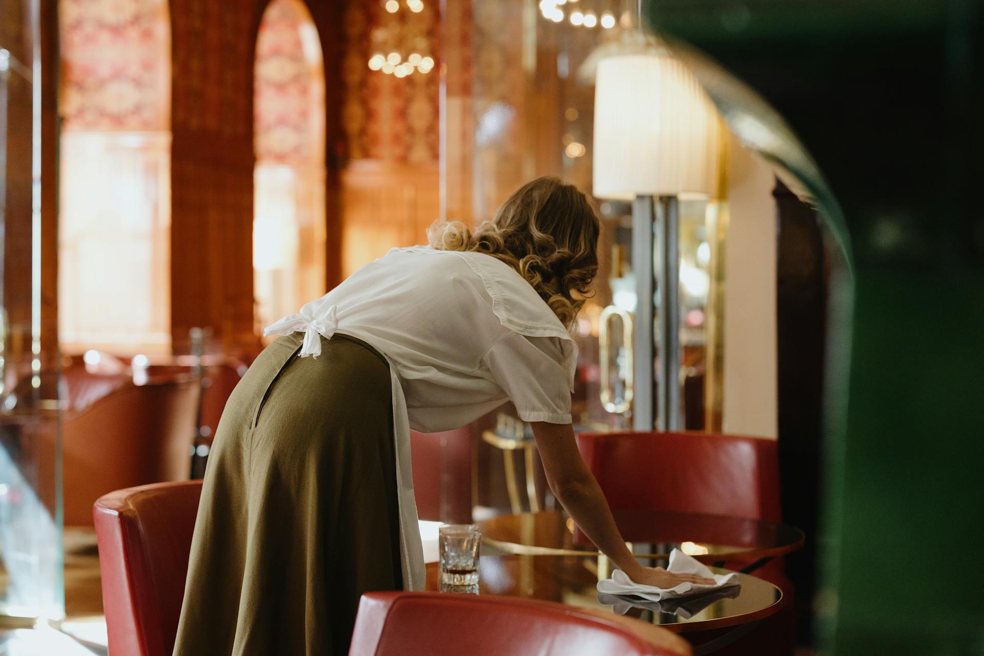 A woman wiping the table | Source: Pexels